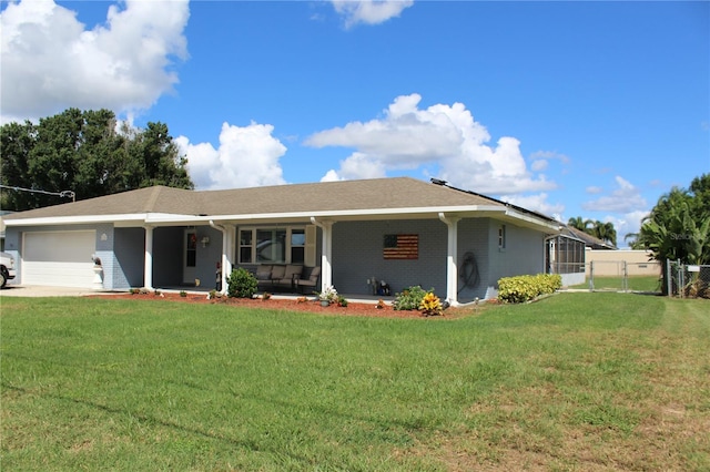 view of front facade featuring an attached garage, covered porch, a gate, a front lawn, and brick siding