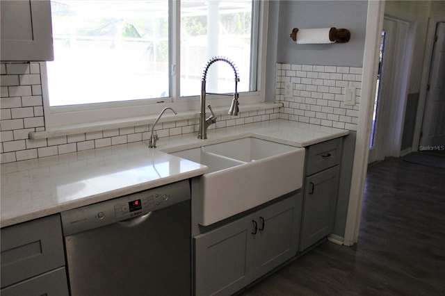 kitchen featuring plenty of natural light, stainless steel dishwasher, and decorative backsplash