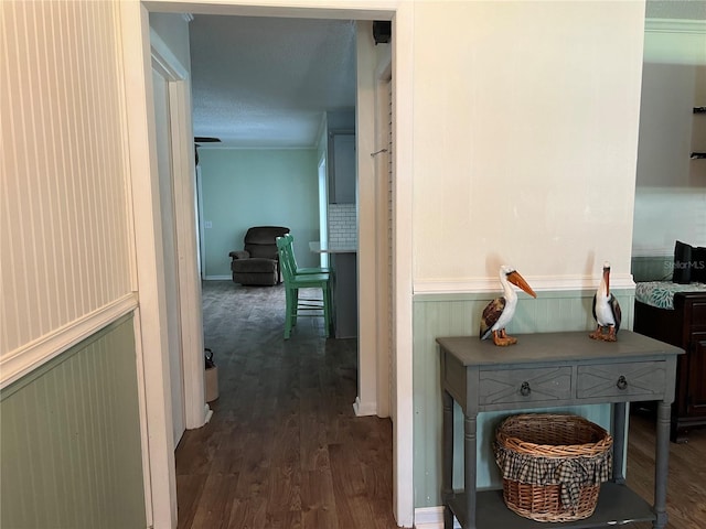 hallway with dark hardwood / wood-style floors and a textured ceiling