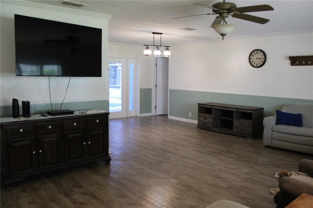 living room featuring crown molding, dark wood-type flooring, a ceiling fan, and visible vents