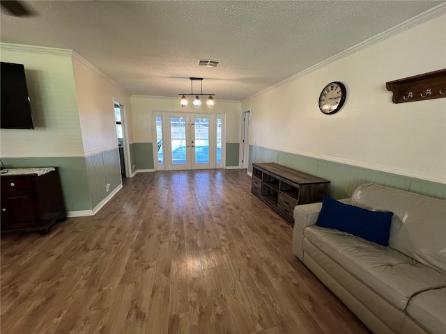 living room with ornamental molding, french doors, a textured ceiling, and dark hardwood / wood-style floors