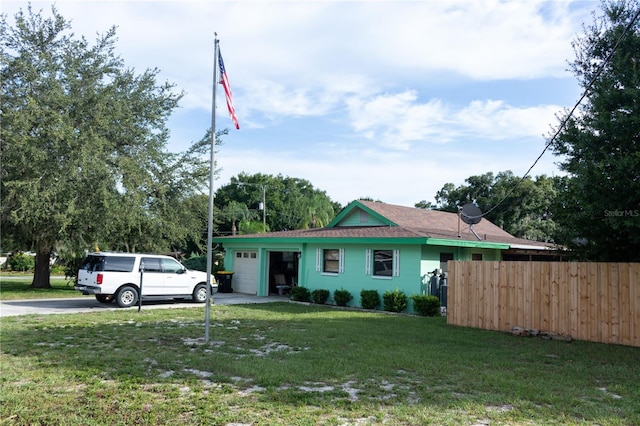 view of home's exterior with a garage and a yard