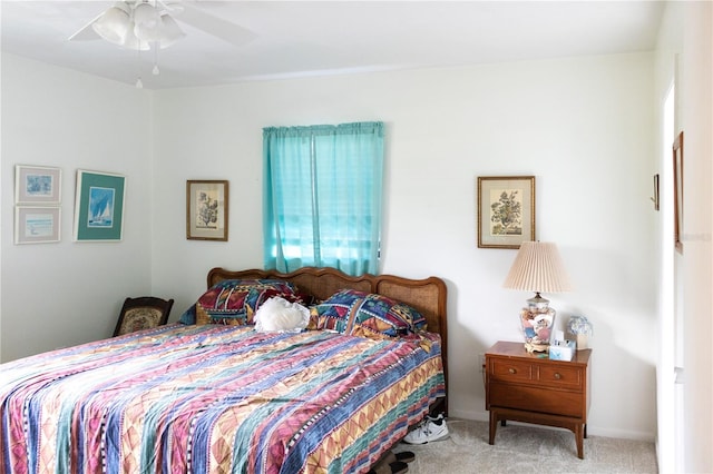 bedroom with light carpet and ceiling fan