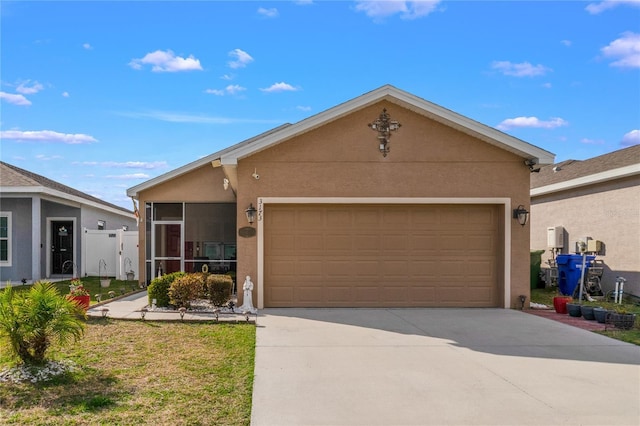 ranch-style house featuring concrete driveway, an attached garage, a sunroom, and stucco siding