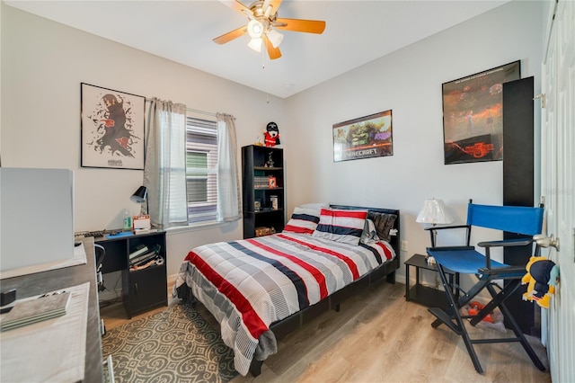 bedroom with light hardwood / wood-style flooring and ceiling fan