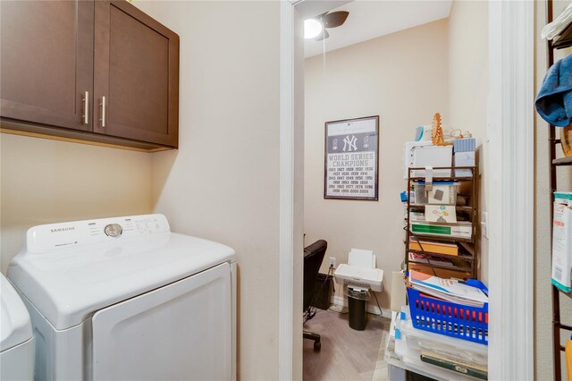 washroom with ceiling fan, cabinets, hardwood / wood-style flooring, and washing machine and clothes dryer