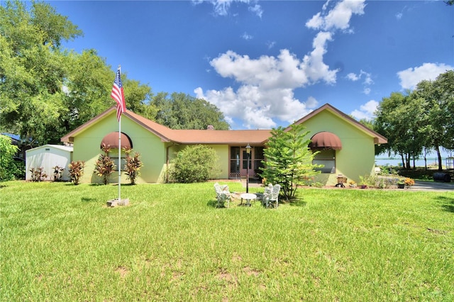 ranch-style home featuring a front yard