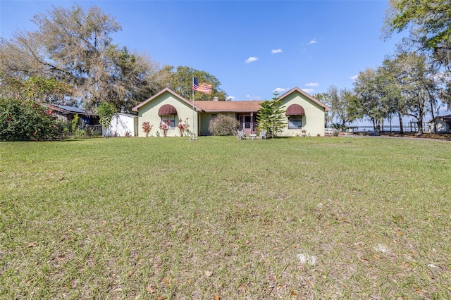 ranch-style house with a front lawn