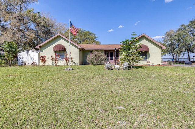 single story home with a front yard and stucco siding