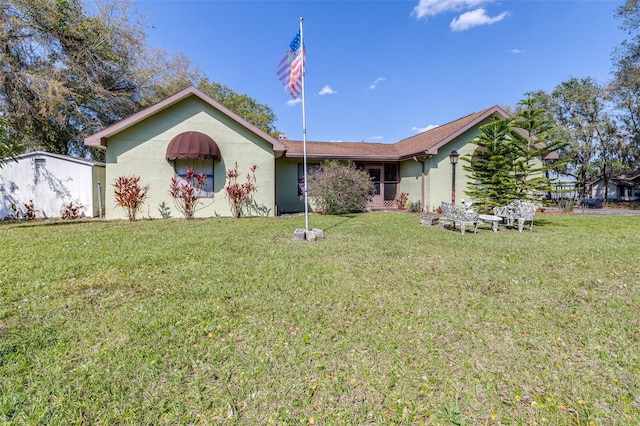 single story home with a front yard and stucco siding