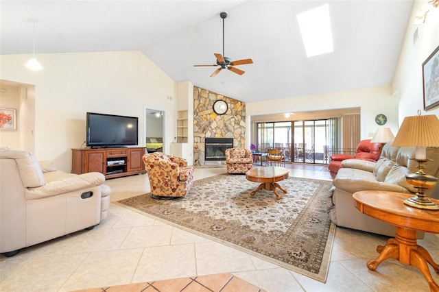 living room featuring high vaulted ceiling, a fireplace, ceiling fan, and light tile patterned floors