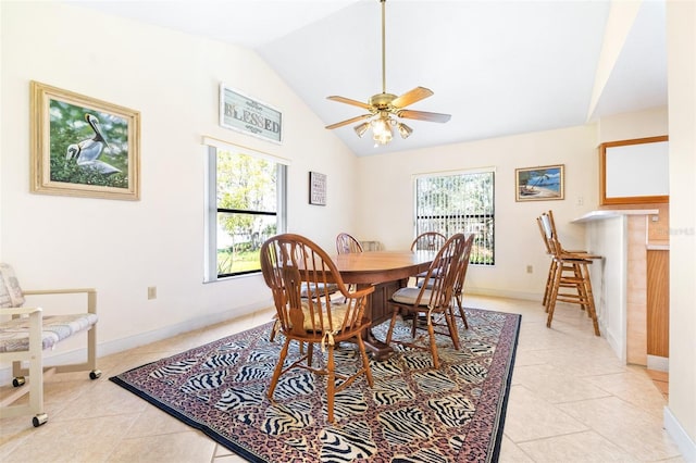 dining space featuring a healthy amount of sunlight, light tile patterned floors, and vaulted ceiling