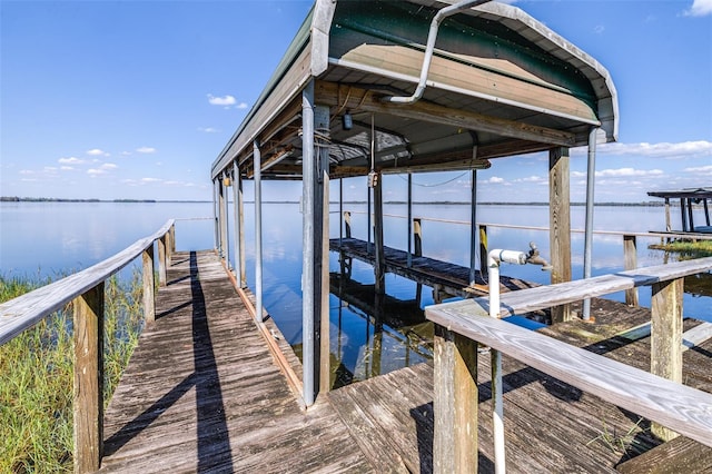 view of dock featuring a water view and boat lift