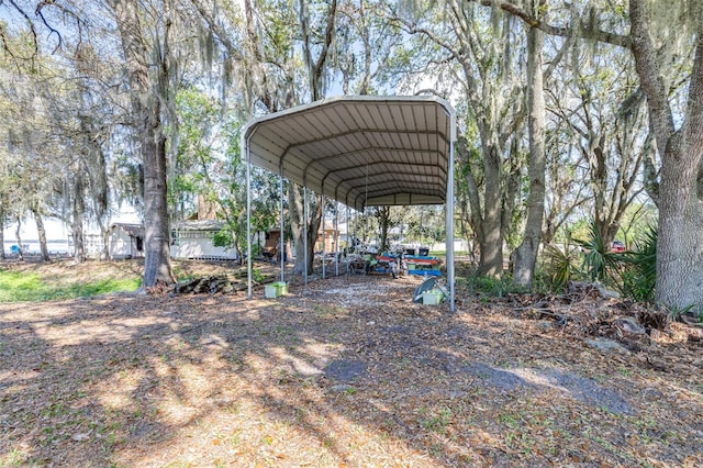 view of parking / parking lot with driveway and a detached carport