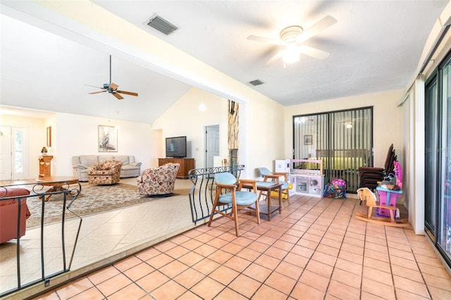 living room with ceiling fan, light tile patterned flooring, lofted ceiling, and visible vents