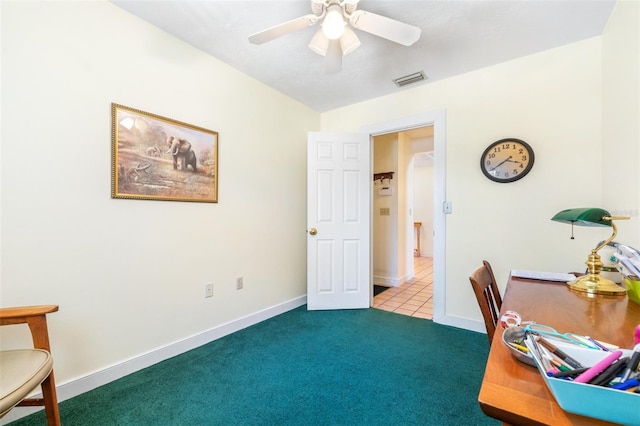 carpeted home office featuring baseboards, visible vents, and a ceiling fan