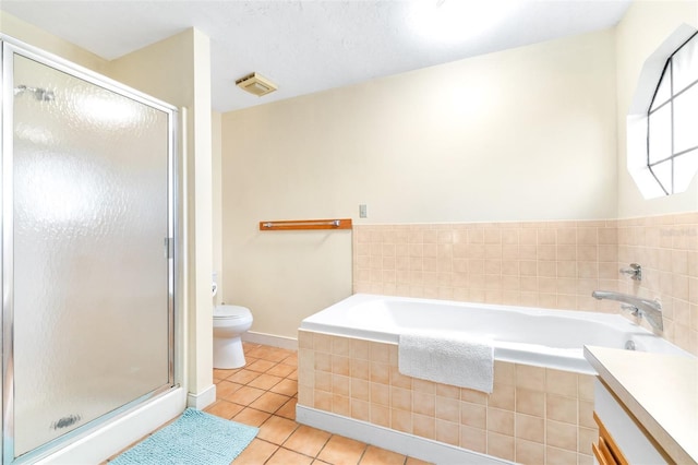 bathroom featuring tile patterned flooring, a garden tub, a shower stall, and toilet