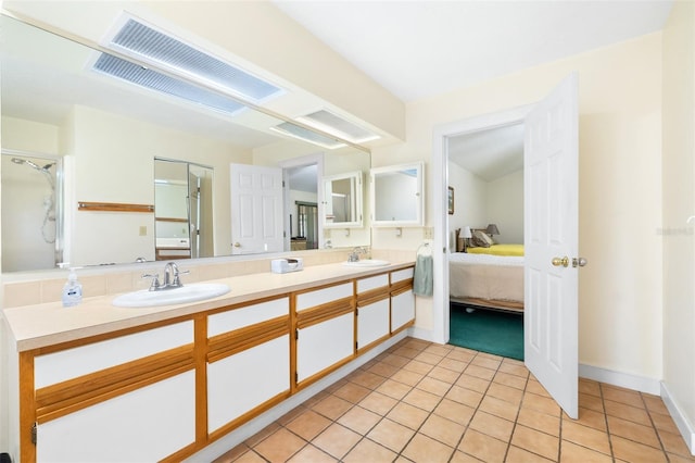 full bath with connected bathroom, a sink, tile patterned floors, double vanity, and an enclosed shower