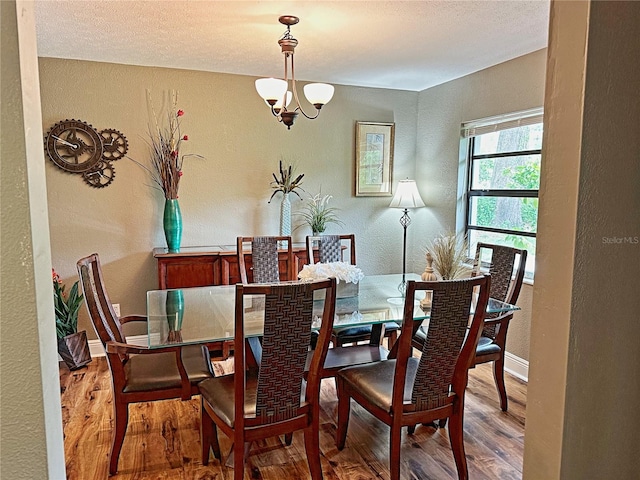 dining room featuring hardwood / wood-style floors and a notable chandelier