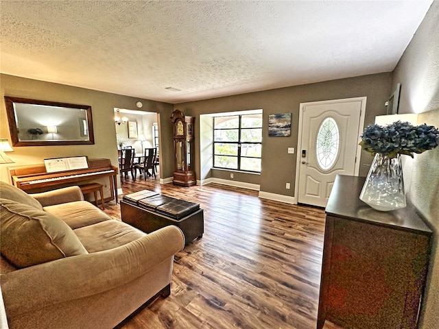 living room with wood-type flooring and a textured ceiling