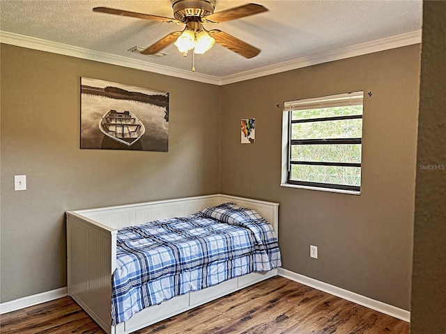 bedroom with hardwood / wood-style floors, ornamental molding, a textured ceiling, and ceiling fan