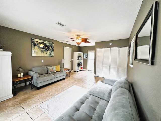 tiled living room featuring ceiling fan