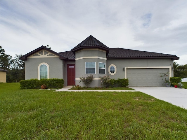 view of front of property with a garage and a front lawn