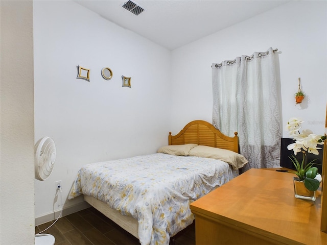 bedroom with dark wood-type flooring