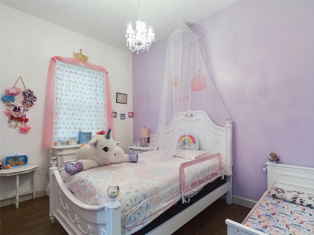 bedroom with dark wood-type flooring and a notable chandelier