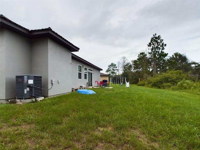 view of yard featuring cooling unit and a playground