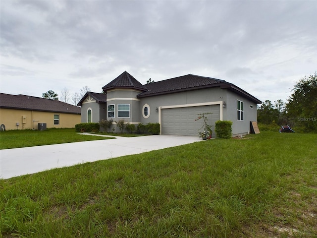 view of front of home with a garage and a front yard