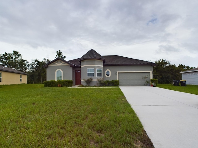 view of front of property with a garage and a front lawn