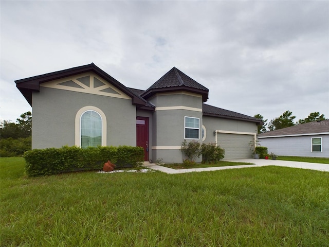 view of front of home featuring a garage and a front yard