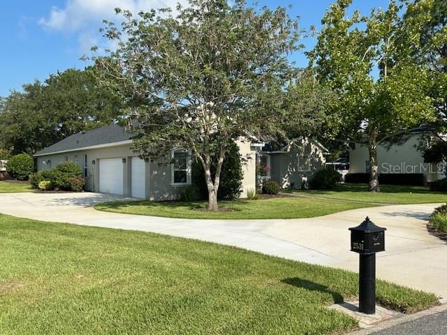 view of front of property with a front yard and a garage