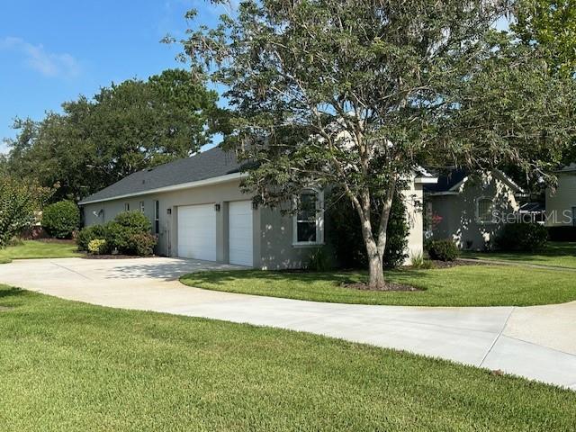 view of front of home with a front yard and a garage