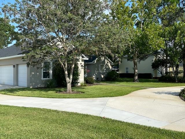 view of front facade with a garage and a front lawn