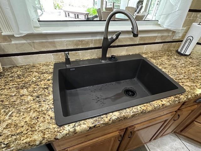 room details featuring sink and tile patterned flooring