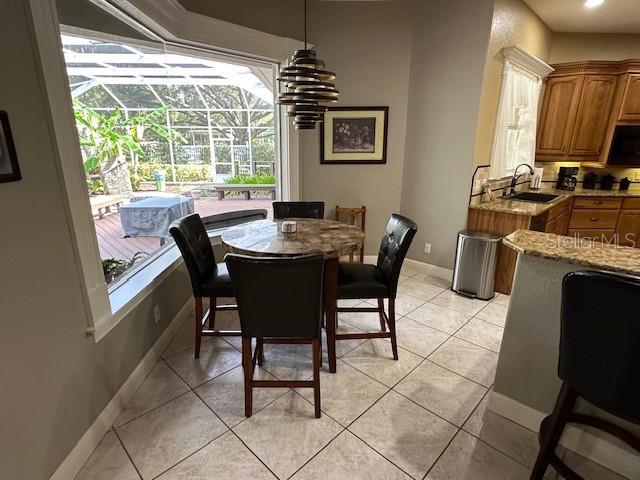 dining area with sink and light tile patterned floors