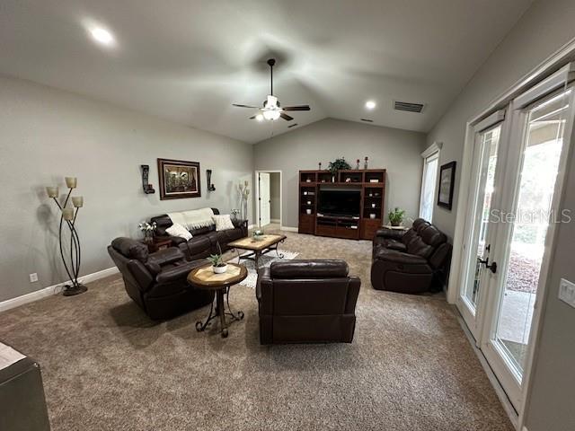 carpeted living room featuring lofted ceiling and ceiling fan