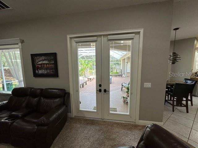 doorway to outside with light tile patterned flooring, french doors, and a wealth of natural light