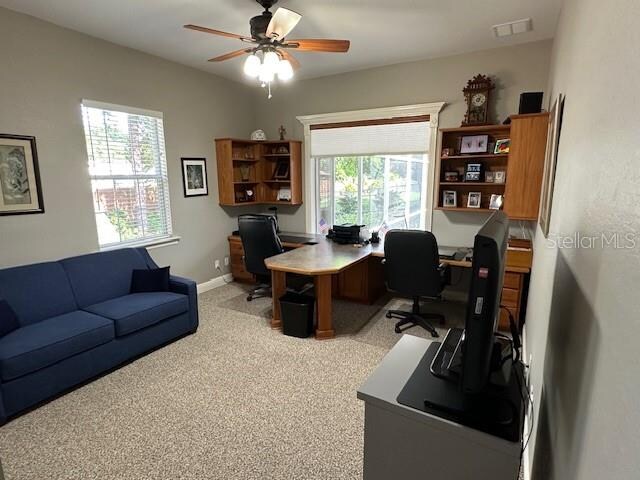 office area with ceiling fan and light colored carpet