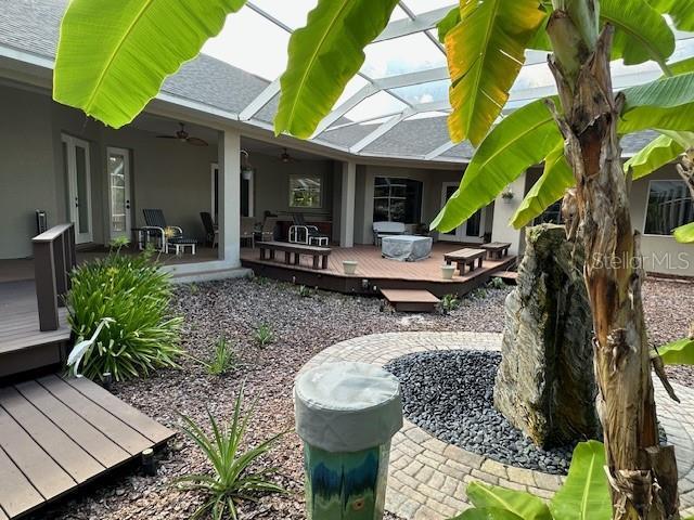 view of yard featuring ceiling fan and a deck