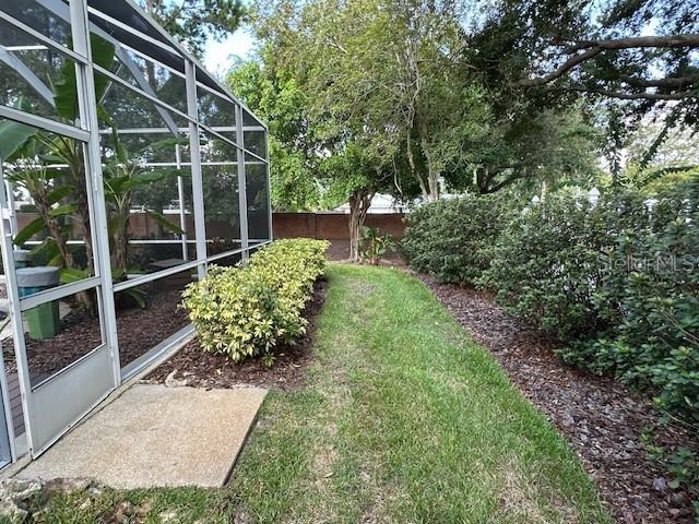 view of yard with glass enclosure