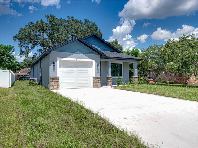 view of front of house with a garage and a front yard