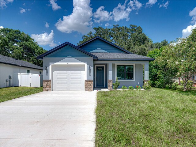 view of front of property with a front yard and a garage