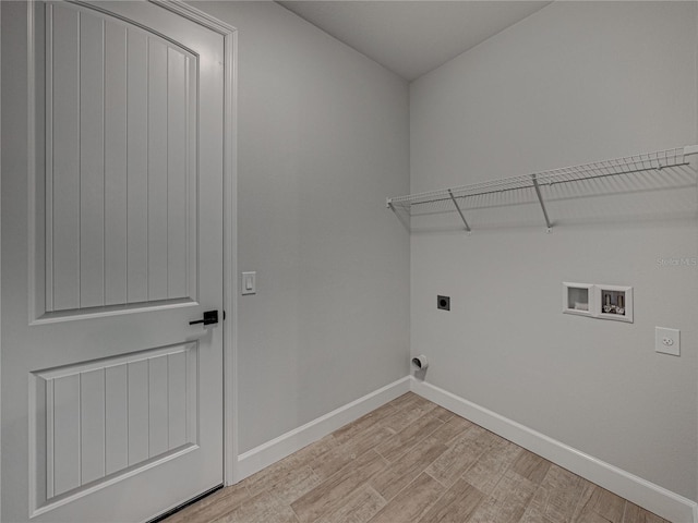 washroom with light hardwood / wood-style flooring, hookup for an electric dryer, and washer hookup