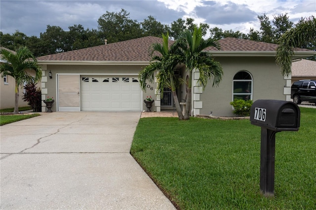 view of front of house with a garage and a front yard