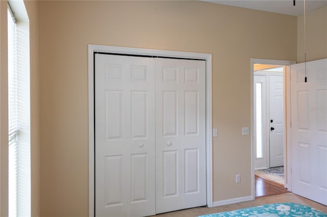 unfurnished bedroom with a closet and light wood-type flooring