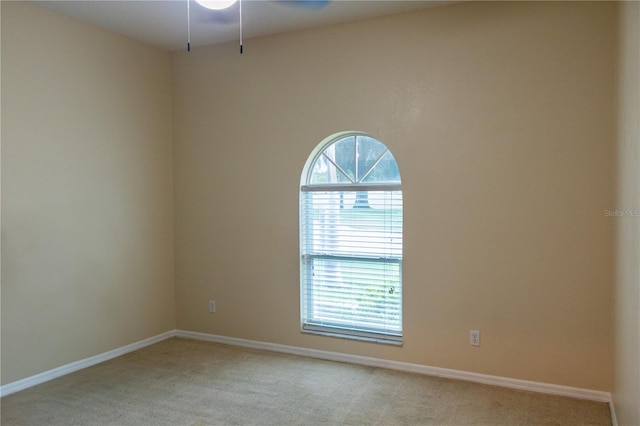 empty room with carpet flooring and ceiling fan