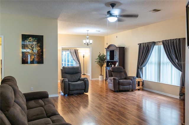 living room with a textured ceiling and hardwood / wood-style floors